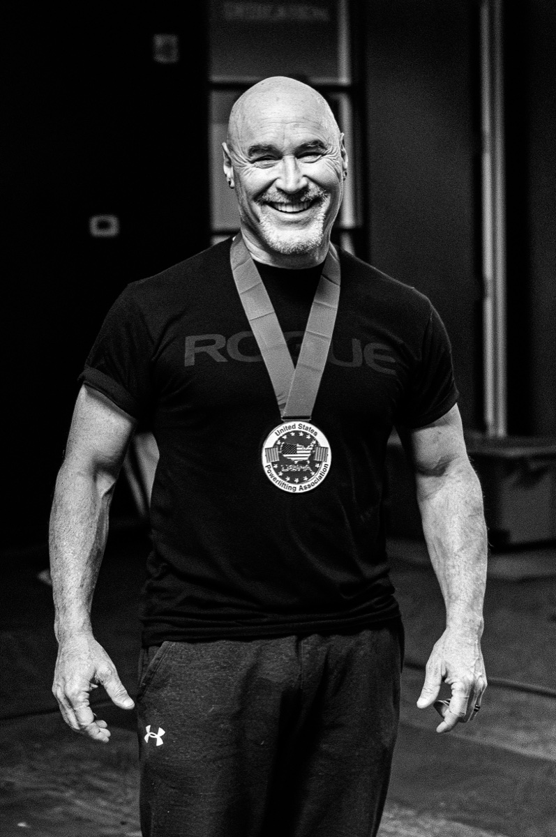Michael Kranitz wearing his United States Powerlifting Association medal